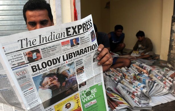 آسيويون يقرأون خبر مقتل القذافي
