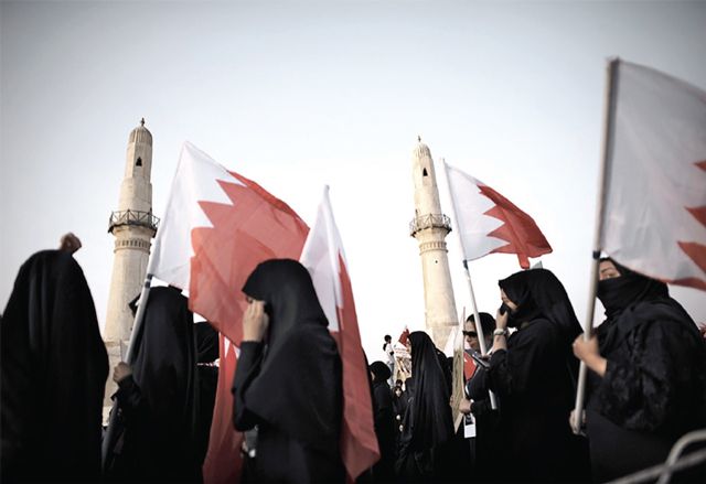 نساء يحملن أعلام البحرين في تظاهرة أمس  -AFP