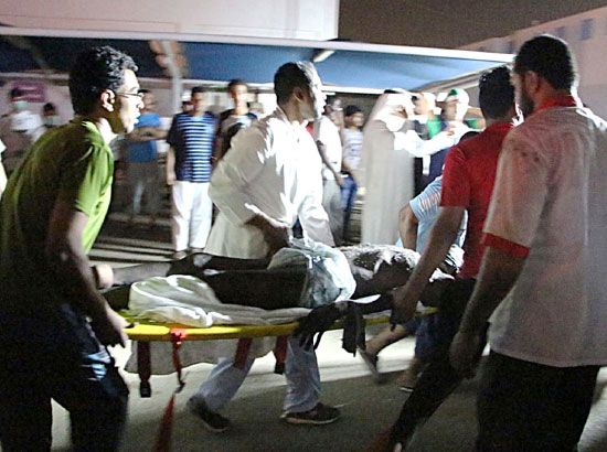 مسعفون ينقلون جثة أحد الضحايا من داخل مستشفى جازان - afp