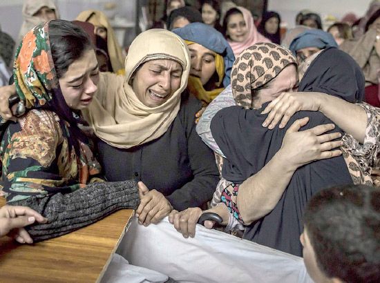 نساء يبكين قريبهن الطفل محمد علي خان الذي قُتل في الهجوم على المدرسة - أرشيفية reuters