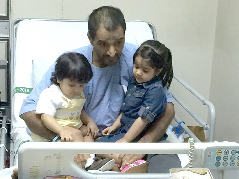 زهراء وعبدالله في حضن أبيهما على سرير المستشفى