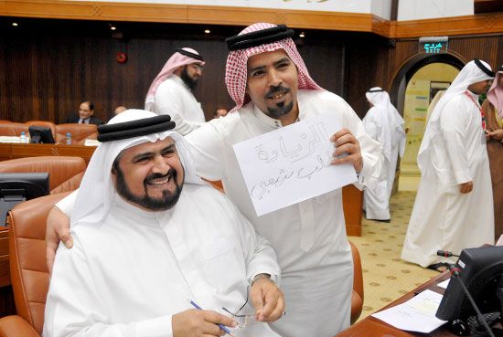 الشمطوط حاملاً ورقة تُطالب بزيادة الرواتب